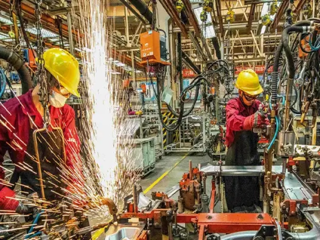 خط توليد صنعتي که کارگران و دستگاه هاي پيشرفته در آن مشغول فعاليت هستند و فرآيند توليد